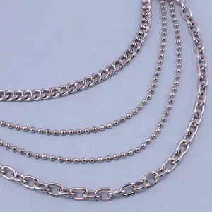 Detalle de cadenas de cintura multicapa en metal plateado con eslabones variados