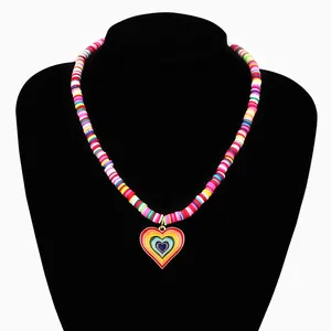 Macro detail of bohemian rainbow clay bead necklace with heart pendant on neck bust