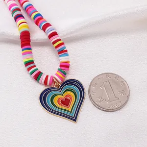 Macro shot of colorful polymer clay bead necklace with vibrant rainbow heart pendant