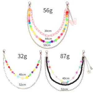 Detailed view of layered beaded waist chains with butterfly charms and length specifications