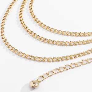 Detailed view of glossy gold heart pendant and metal link waist chain decoration