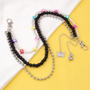 Detail of multi-layer hip-hop waist chain with pink butterfly and colorful floral beads