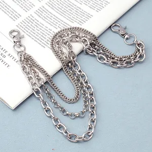 Detail of triple-layer silver metal pants chains with lobster clasps on a vintage book