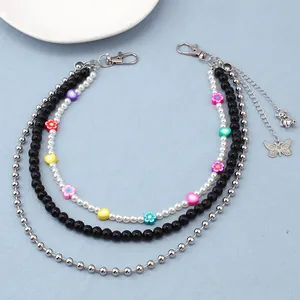 Detailed macro view of the three-layer colorful beaded chain with heart and butterfly charms