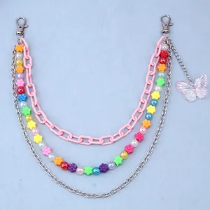 Detail of multi-layer body chain with pink butterfly pendant and colorful beads