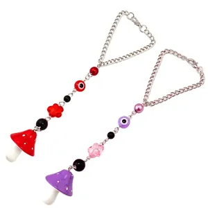 Detailed view of handmade beaded mushroom charms with evil eye beads and metal chains