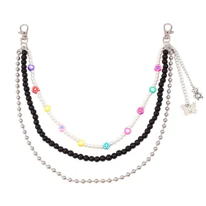 Detail of multi-layered hip-hop body chain with colorful resin flowers and butterfly charm