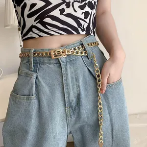 Gold layered chain belt with square buckle worn on high-waist jeans for women