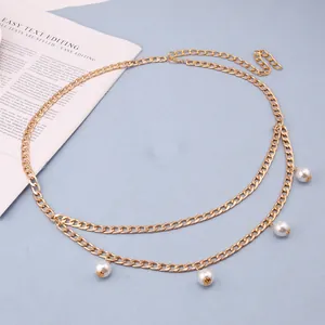 Close-up of double-layer gold chain belt with white pearls for elegant dress accessories