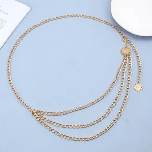 Macro view of gold layered metal waist chain with sun flower and swan engraving detail