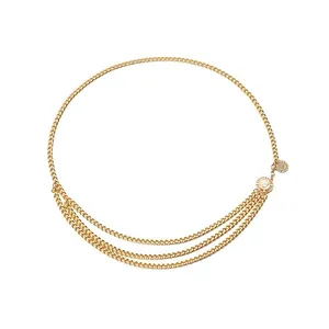 Detail of gold multilayer metal waist chain with textured coin pendants and layered drapes