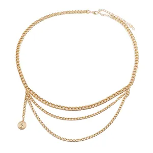 Detail of multi-layered gold belly chain featuring a classic portrait coin pendant charm