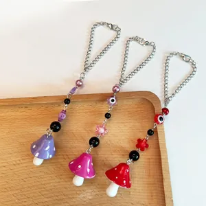 Pendentifs champignons perlés avec œil maléfique et fleurs en violet et rouge