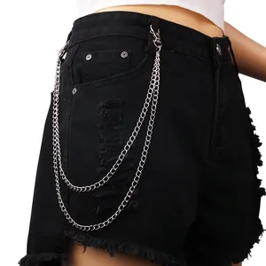 Punk style black denim shorts with layered silver metal chains and ripped fringe detail