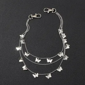 Detailed view of silver triple-layered metal pant chain with butterfly charms and lobster clasps