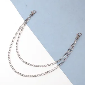 Detail view of double-layered silver metal pant chain with dual lobster clasps