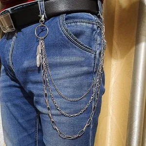 Close-up of three-layered silver metal wallet chain with feather pendant on denim