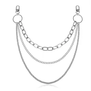 Detailed view of silver triple-layered metal pant chain with lobster clasps and rings