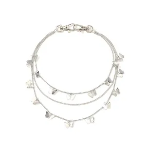 Three-layer silver metal chain necklace with butterfly pendants on a white background