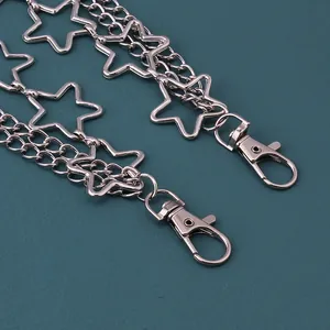 Detailed view of silver layered metal chains featuring hollow star charms and lobster clasps