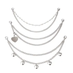 Detail of silver multi-layer bag chain with heart pendants and faux pearls with clasps