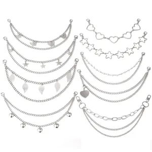 Macro view of silver metal bag chains with butterfly, star, and heart charms details