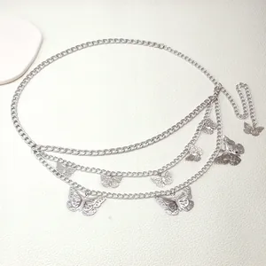 Detail of silver multilayer waist chain featuring hanging hollow metal butterfly charms