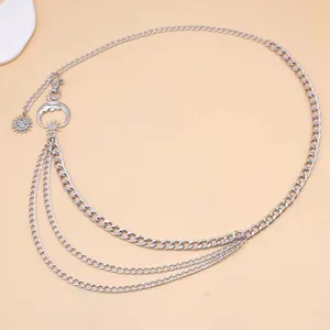Detail of multi-layer silver metal waist chain featuring moon and sun pendants