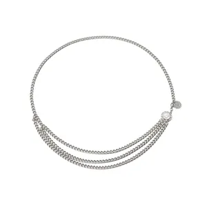 Macro shot of silver multi-layer metal chain belt with sun pattern and flower pendant