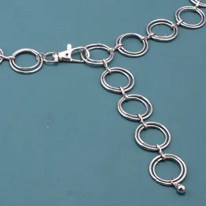 Close-up of silver punk double-ring waist chain with lobster clasp and metal ball pendant