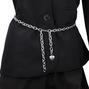 Silver chain body belt with layered tassel and engraved heart pendant on black suit
