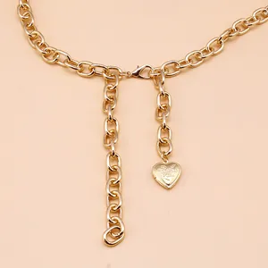 Detail of gold cross chain with engraved I Love You heart pendant and lobster clasp