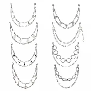 Detail showing assorted silver layered chains with butterfly, coin, and cross charms