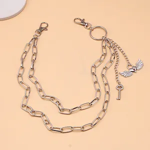Detail of multi-layered silver metal pants chain with heart wing and key charms