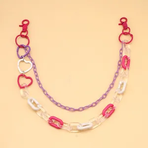 Detail of double-layer acrylic and metal pants chain with colorful heart-shaped links