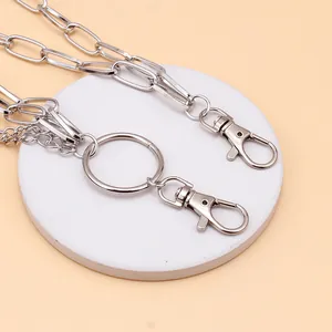 Close-up of silver multilayer trousers chain with heart wing pendant and lobster clasps