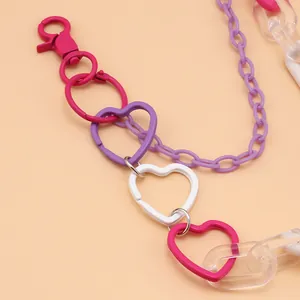 Detail of pink and purple acrylic chain links with heart-shaped metal lobster clasps