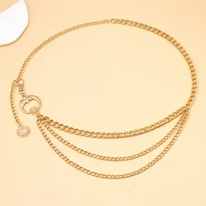 Detail of layered gold moon and sun chain belt featuring bohemian pendant charms