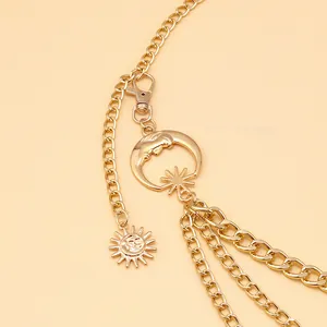 Detailed view of bohemian gold multilayer waist chain with sun and crescent moon charms