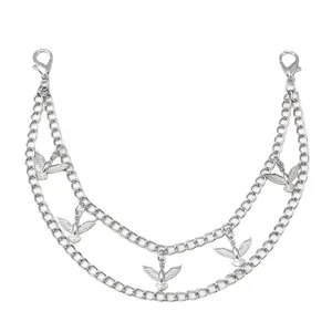 Macro detail of double-layer silver chain with bird pendants and lobster clasps for bags