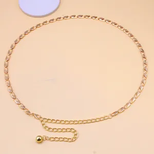 Close-up of golden metal waist chain featuring rectangle links and ball pendant charm