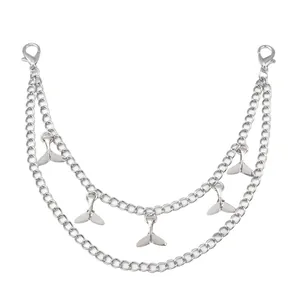 Detail view of double layer silver metal chains with delicate fishtail charms and clasps