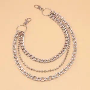 Detailed macro of a triple-layered punk metal pant chain with silver links and lobster clasps