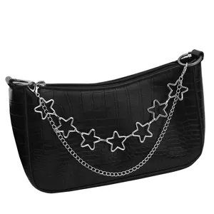 Detail of black faux crocodile skin hobo bag with silver star chain and metal link strap