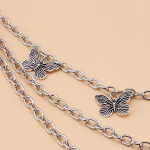 Close-up of a silver multi-layered butterfly chain with retro metal rings for punk styling