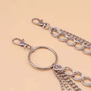 Detail of layered silver metal waist chain with feather pendant and lobster clasps