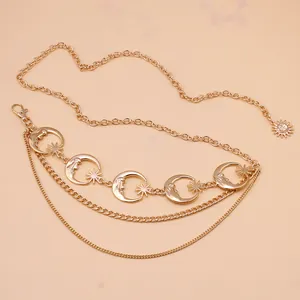 Layered gold metal waist chain featuring crescent moon, star and sun pendant charms