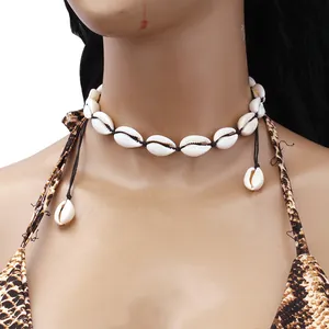 Handmade shell choker necklace with natural white cowrie shells on black woven cord
