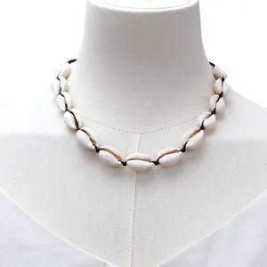 Detailed view of handmade cowrie shell necklace with knotted black cord for summer beach wear