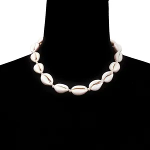 Close-up of handmade shell choker necklace with natural white shells on black neck model